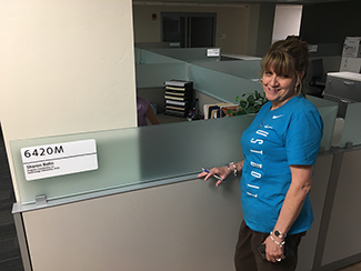 Sharon Bolin next to her new cubicle as part of the Medical Education Office staff