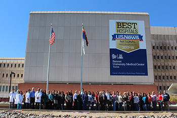 Staff in front of new Banner - UMC/U.S. News signage