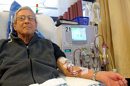 A patient hooked up to a hemodialysis machine