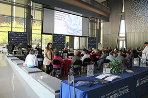 [The audience at the Living Healthy With Arthritis Symposium's climate change and health panel discussion listens in rapt attention as panelists discuss various ways the two issues are entertwined.]