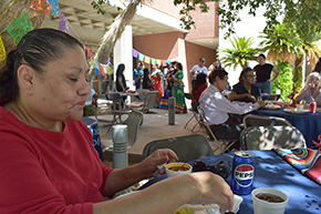 [Lisa Torres-Jones, an administrative associate in the DOM Office of the Chair, enjoys birria tacos and jamaica served at the Hispanic Heritage Month Celebration in between the AHS Library, Sarver Heart Center, College of Pharmacy and Health Sciences Innovation Building]