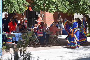 [Dancers from the U of A Folklorico Program sashay and swing their skirts on traditional Mexican dresses at the UAHS Hispanic Heritage Month Celebration.]