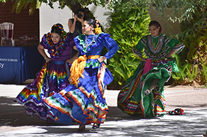 [Dancers from the U of A Folklorico Program sashay and swing their skirts on traditional Mexican dresses at the UAHS Hispanic Heritage Month Celebration.]