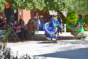 [Dancers from the U of A Folklorico Program sashay and swing their skirts on traditional Mexican dresses at the UAHS Hispanic Heritage Month Celebration.]