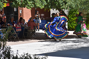 [Dancers from the U of A Folklorico Program sashay and swing their skirts on traditional Mexican dresses at the UAHS Hispanic Heritage Month Celebration.]