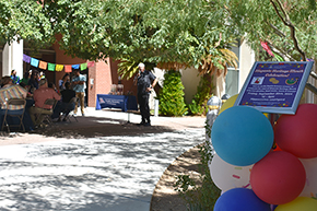 [Balloons around signage for the UAHS Hispanic Heritage Month Celebration as Dr. Francisco Moreno readies to speak.]