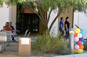 [At right, Tyler Wong, Ambulatory Medicine Clerkship coordinator, and Bersabe Lopez, Nephrology Fellowship coordinator, walk toward Mexican food truck at UAHS Hispanic Heritage Month Celebration.]