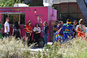 [U of A Folklorico dancers gather at Ensenada Street Food truck for tacos.]