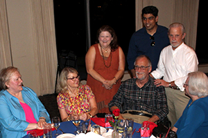 Drs. Tom Boyer (seated) and John Cunningham (standing in white shirt) at their retirement party Aug. 12, 2017