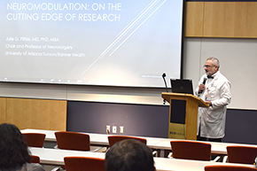 [Friday Frontiers host Dr. Bekir Tanriover, chief of the Division of Nephrology in the UArizona College of Medicine’s Department of Medicine, introduces Dr. Julie Pilitsis, chair of the college’s Department of Neurosurgery.]