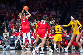 [U of A’s Jada Williams (#2), who finished with 18 points, leaps into the air to shoot a basket.]