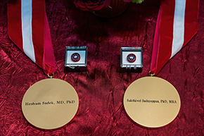 [Medallions that accompany an investiture, here emblazoned with the names of Drs. Hesham Sadek and Sakthivel Sadayappan.]