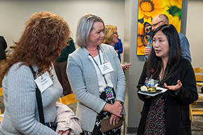 [Division of Cardiology’s Christa Hamilton and Nicole Contreras listen to Department of Medicine Administrator Phet Chen at the College of Medicine – Tucson investiture ceremony for Drs. Hesham Sadek and Sakthivel Sadayappan.]