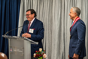 [Sharing a laugh during investiture ceremony are College of Medicine – Tucson Dean Michael Abecassis, MD, MBA, and Hesham Sadek, MD, PhD, Cardiology division chief and Sarver Heart Center director.]