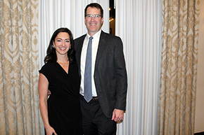 [A man and a woman in front of beige drapery in a ballroom at the Arizona Inn.]