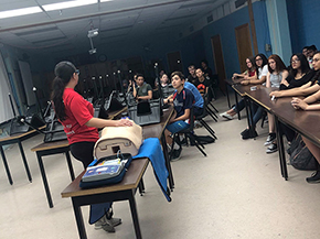 Health education assistant Erika Yee instructs high school students on the benefits of chest-compression-only CPR