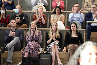 [Faculty, including Drs. Amy Klein and Jennifer Plitt, of the Division of General Internal Medicine, Geriatrics & Palliative Medicine, applaud an honored faculty member as their name is announced.]