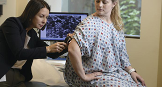 Dr. Clara Curiel-Lewandrowski examines a patient