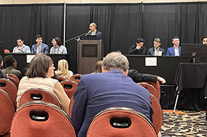 [The Doctor’s Dilemma competition pitting (on the left) the U of A College of Medicine – Tucson medical students Curtis Josephs, Jacob Ref and David Mintz (MS4s) and the U of A Internal Medicine resident team, Nelson Pham, MD, Nate Walton, MD, and Will Waidelich, MD]