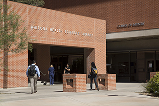 [Photo of people entering the Arizona Health Sciences Library in Tucson]