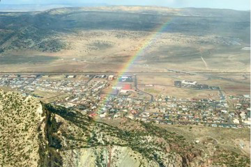 [An aerial view from a small airplane with a rainbow]