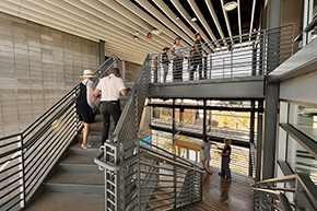 [With a visual crisscross of patterns, open house guests navigate the stairwell of the Mind building at the Andrew Weil Center for Integrative Medicine's new complex]