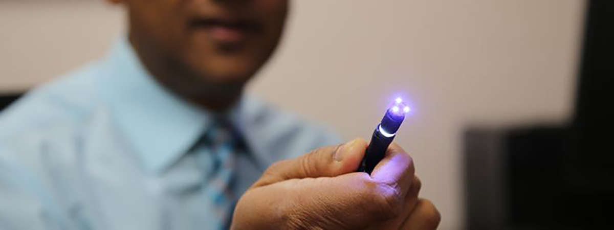 Co-inventor Dr. Bhaskar Banerjee with a prototype of the new probe.