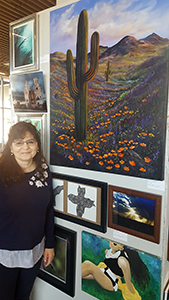 Carolyn Bothwell, Division of Infectious Diseases, with her painting of saguaro and Mexican poppies (courtesy of Karena Nespoli)