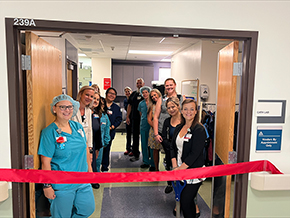 Staffers at Banner – University Medical Center South hospital gather in the soon-to-be reopened cardiac cath lab for a ribbon-cutting on July 10, 2023, to celebrate its renovation.