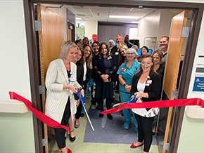 Scissor wielders Naphtali Kahl, RN (in white coat), and Brittany Davis, RN (right), director associate director of cardiology services at Banner – University Medical Center South, cut the ribbon to reopen the cardiac cath lab, which was renovated over the past year.