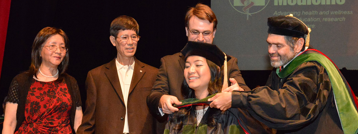 [Elaine Situ-LaCasse, MD, receiving her medical degree at the Class of 2013 convocation ceremony]