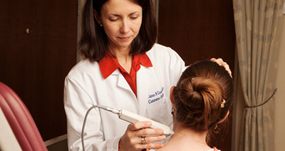 Dr. Curiel-Lewandrowski works with a patient at the UA Skin Cancer Institute