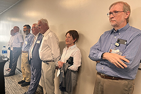[Drs. Geoffrey Block (right), a hepatologist and director of the Boyer Liver Institute; Karl Kern (4th from right), a former cardiologist; and Neil Ampel (5th from right), an infectious diseases specialist – and others listen to speakers at Dalen-Smith Memorial.]