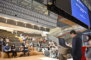 Photo of audience gathered in HSIB Forum for the University of Arizona Department of Medicine's 2023 Awards Ceremony with Chair James K. Liao, MD, and Bersabe Lopez in the foreground on right.