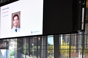 Pictured on overhead screen at Department of Medicine 2023 Awards Ceremony is Andrew Barr, MD, who was not present at the event but won the Endocrinology Outstanding Resident Award.