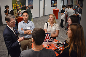 [DOM general internal medicine specialist and COM-T Vice Dean for Education Dr. Kevin Moynahan holds court with a several students with a cup of lemonade.]