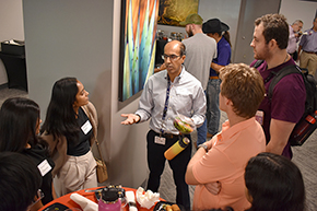 [Dr. Puneet Shroff (center), an allergist with the Pulmonary division, has a lively conversation with several students.]