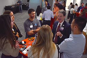 [COM-T Vice Dean for Education Dr. Kevin Moynahan shares a laugh with several students at the Internal Medicine Student Meet-and-Greet on Sept. 11, 2024]