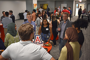 [Transplant pulmonologist Dr. Josh Malo (3rd from right) makes a point in a conversation with students and residents at an Internal Medicine Student Meet-and-Greet.]