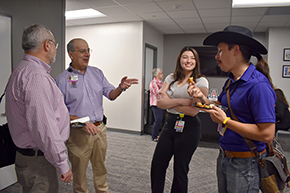 [Residents, Drs. Skyler Trieu (PGY3) and Rosie Turk (PGY2) discuss his cheese-filled and breaded chili pepper with Infectious Diseases’ Dr. Tirdad Zangeneh (gesturing) and Nephrology chief Dr. Bekir Tanriover.]