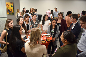 [Pre-med students and med students share a table with Drs. Elise Le Cam and Natalie Davis (chief residents – bottom center) and Dr. Kevin J. Moynahan (right) and his father Dr. Kevin Moynahan (above, 2nd from right).]