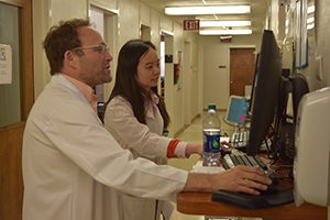 Infectious Diseases fellow Craig Brown, MD, works with Dr. Tey at recent clinic