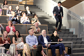 [Internist at the Southern Arizona VA Health Care System and Tucson VA Medical Center and a U of A  assistant professor in the DOM, Robert Kim, MD, descends the steps at the HSIB Forum to receive his COM-T Faculty Award.]