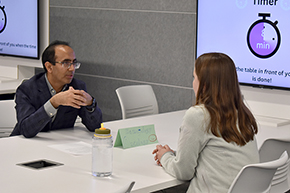 [Dr. Muhammad Husnain, of the Division of Hematology & Oncology, chats with first-year medical student Allison Molzahn. ]