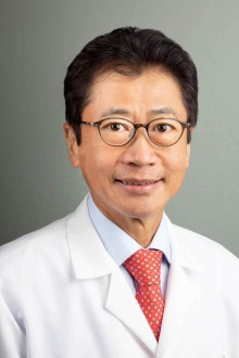 [Portrait of Asian-American man in white doctor’s coat]