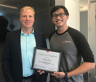 Dr. Yves Lussier (left) maintains a busy schedule of professional commitments but still makes time to mentor students such as Wesley Chiu, a high school senior from Tucson. (Photo: Colleen Kenost)