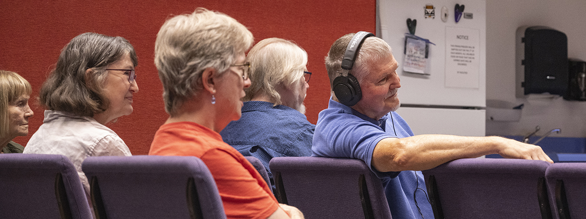 [Four people, including Mel Hector, MD, of the University of Arizona’s College of Medicine – Tucson, watch a reading of Dr. Hector’s play.]