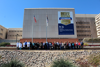 Staff in front of new Banner - UMC/U.S. News signage