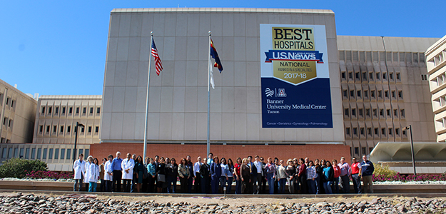 Photo shoot of staff in front of new Banner - UMC/U.S. News signage 