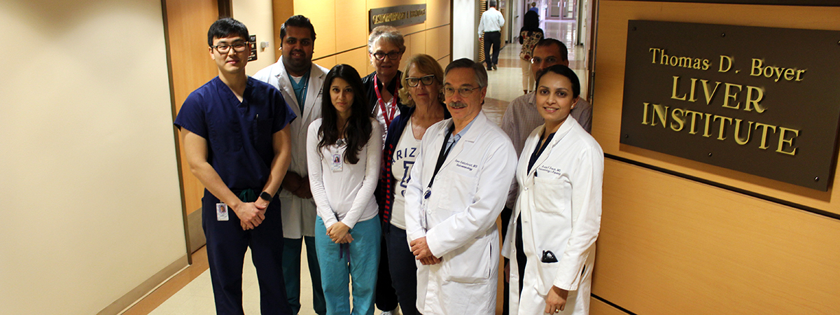 A few Gastroenterology & Hepatology division staff gather in front of new signage